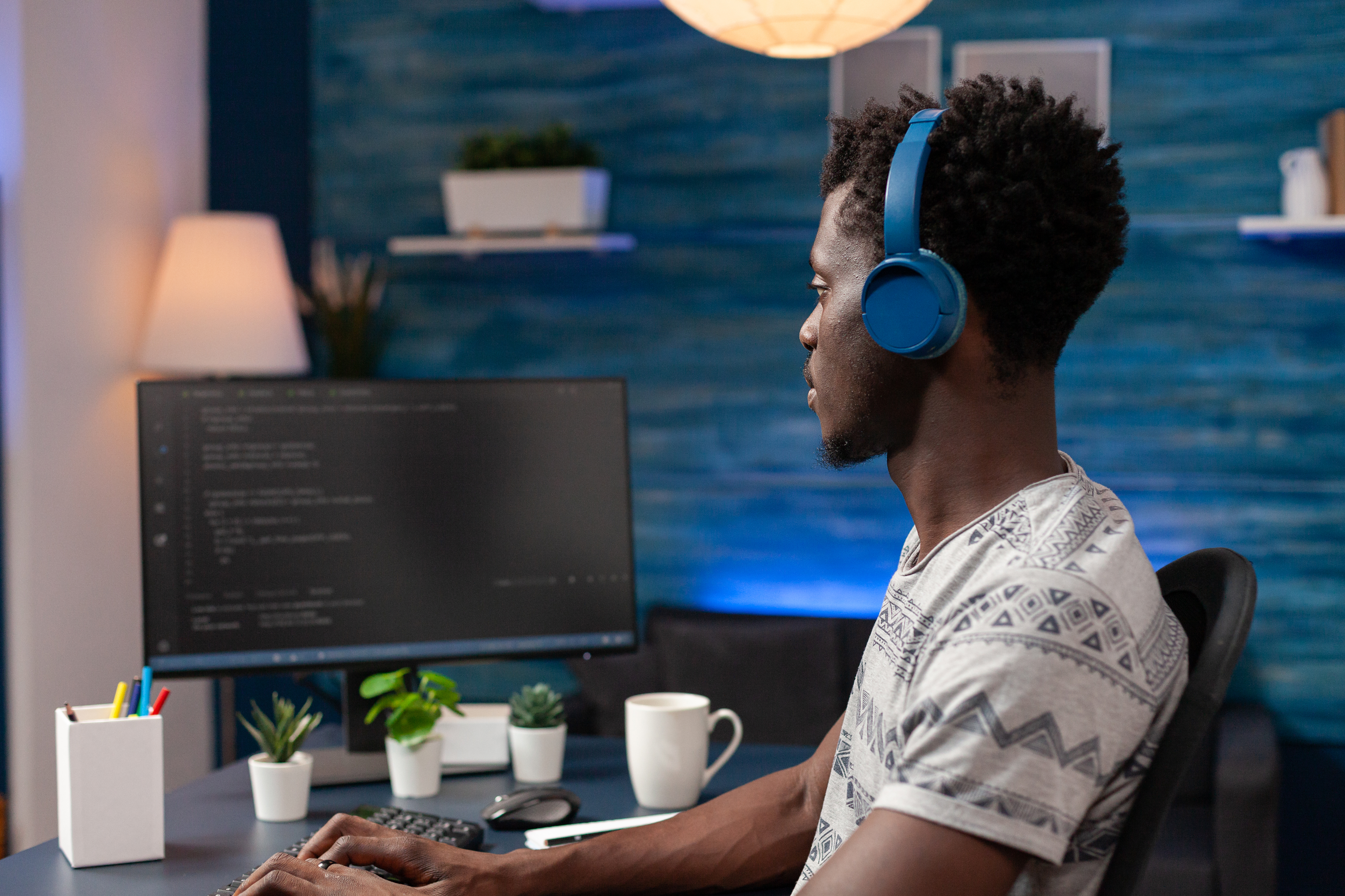African american young programmer wearing headphone